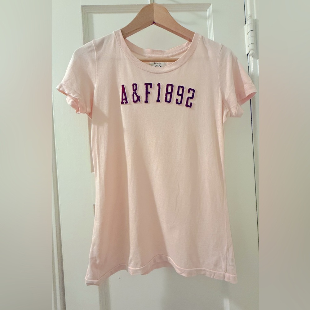 Abercrombie & Fitch Light Pink Tee with collegiate type maroon letter patches